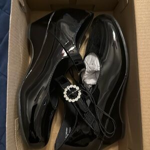 Black dress shoes with velcro strap.